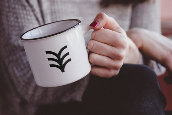 Hand Holding Metal Mug