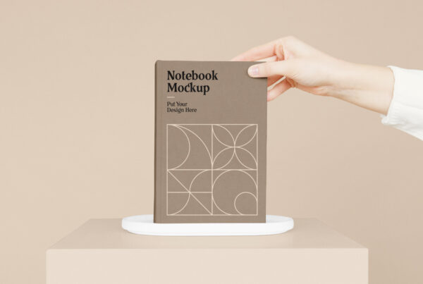 Notebook with Hand Mockup