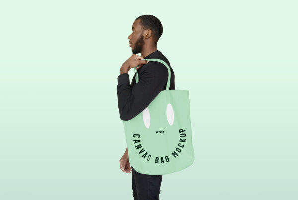 Profile of a Man wearing a Canvas Bag Mockup on a mint background.