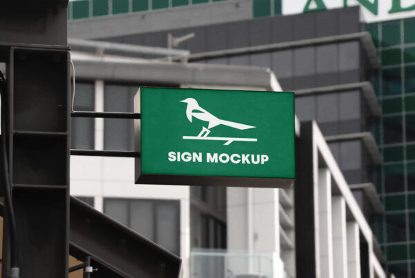 Rectangle Store Sign PSD Mockup hung on the facade of the building.