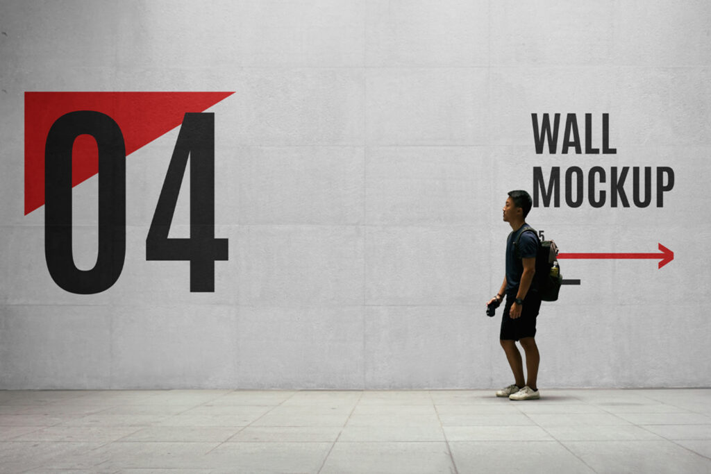 Wayfinding Wall with Men Mockup standing on the sidewalk holding camera and backpack.