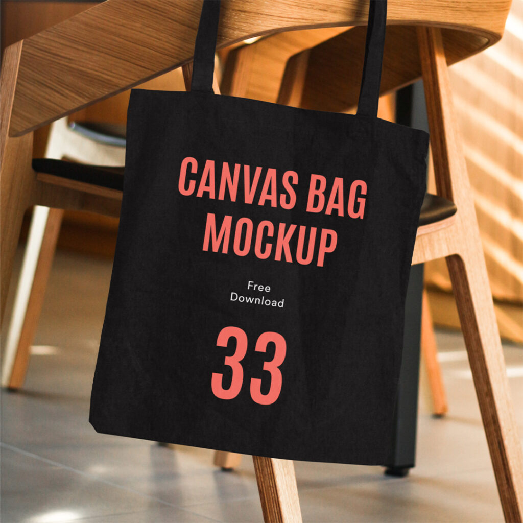 Front view, Canvas Bag Mockup hanging on chair made of wood.