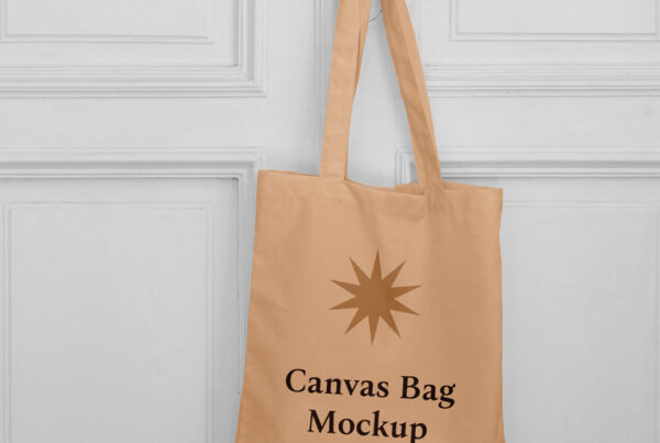 The front of a canvas bag mockup is hanging on the handle.