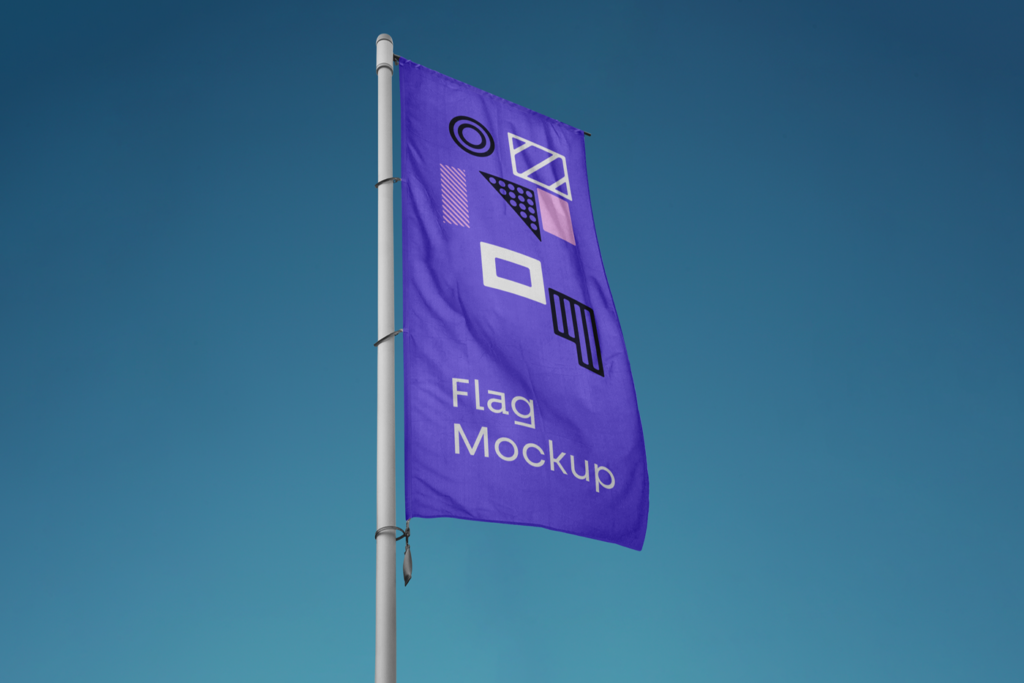 Vertical Flag PSD Mockup against blue sky view.