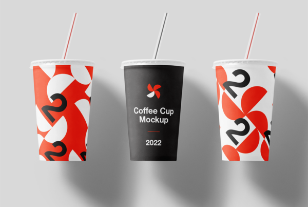 Three Cup with Straw Mockups lie on the gray floor in the studio.