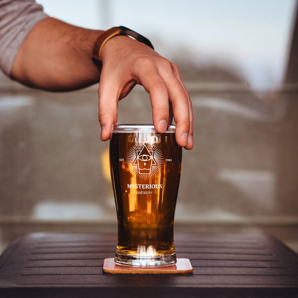 Men holding Beer Glass Mockup from above.