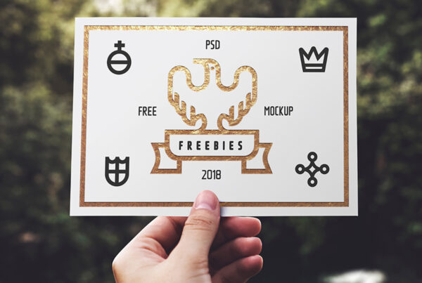 Men hand Holding Blank Card Mockup against the background of greenery.