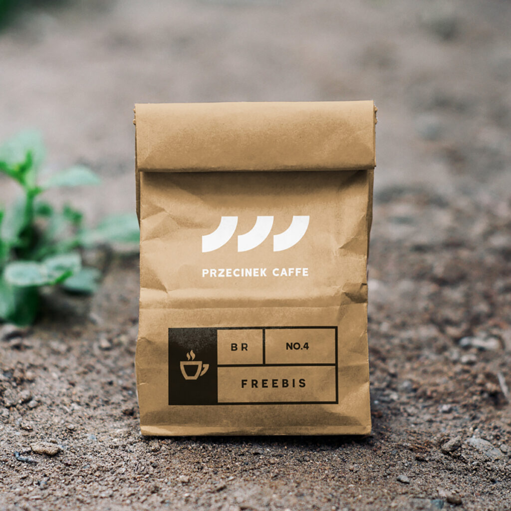 A small craft Paper Bag Mockup is standing on the ground.