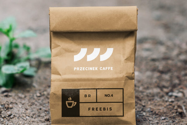 A small craft Paper Bag Mockup is standing on the ground.