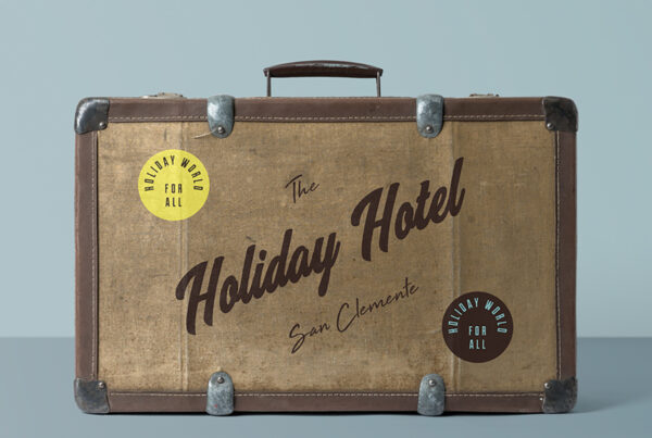 Front view, vintage Suitcase Mockup with metal and leather details standing in photography studio.