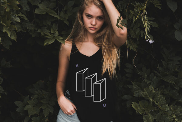 Front view, Women wearing tank top T-Shirt Mockup between the trees.
