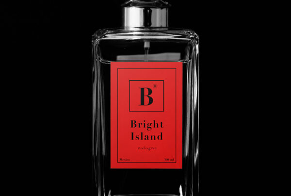 A small glass luxury Perfume Bottle Mockup with red label on the black background behind.