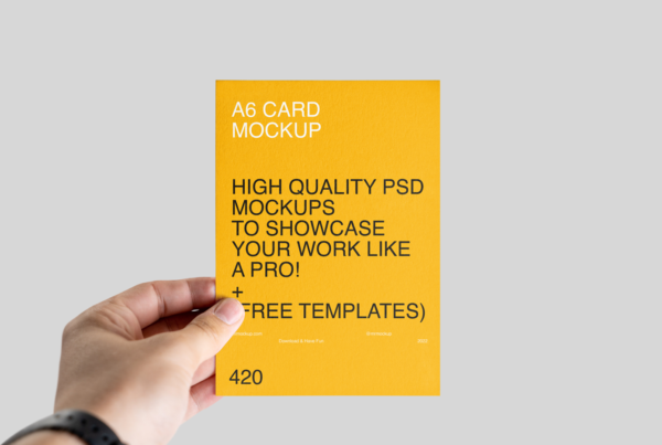 Front view, A6 Leaflet in Hand Mockup on bright gray wall.