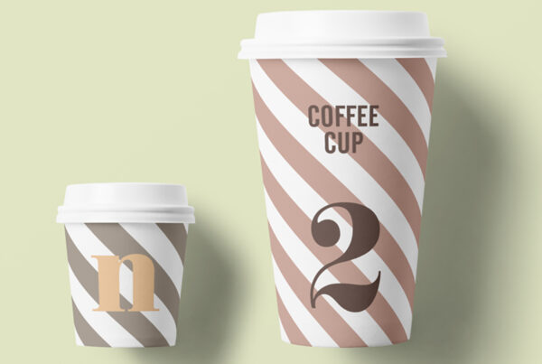 Two Paper Cup Mockups lies on the lime color floor.
