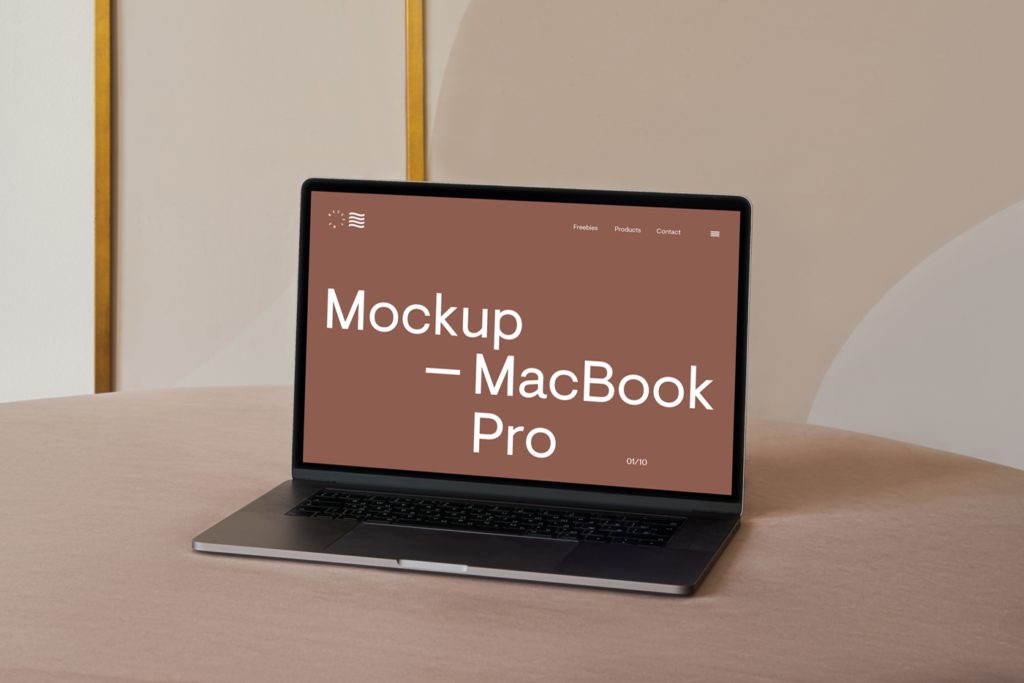 Open MacBook Pro Mockup lies on a beige sofa.