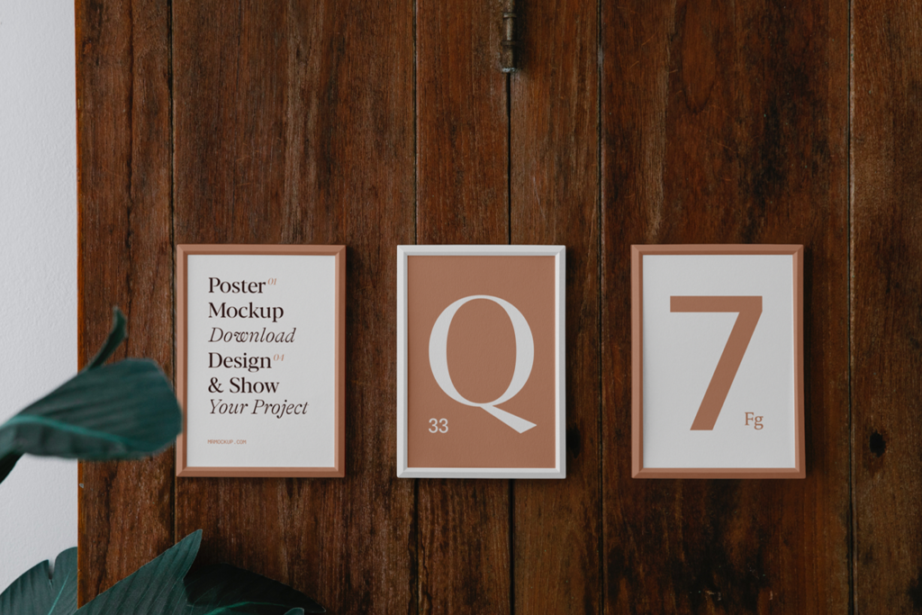 Front view, Three Posters on Wood Wall Mockup with Monstera Deliciosa flower.
