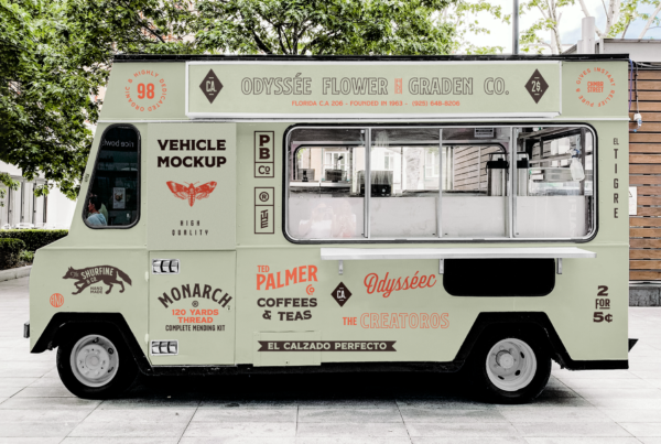 A Vehicle PSD Mockup is parked between buildings and trees.