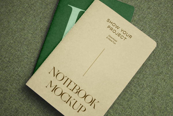 Two Notebook on Sofa PSD Mockups stacked on top of each other at an angle seen from above.