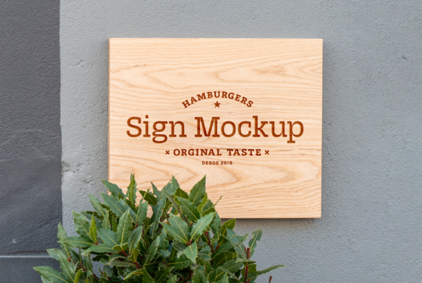 Wood Sign Mockup attached to concrete, bright gray wall.