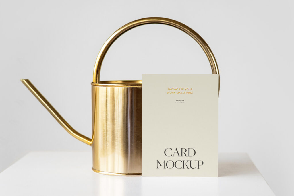 Front view paper card mockup with watering can behind standing on the white cubic.