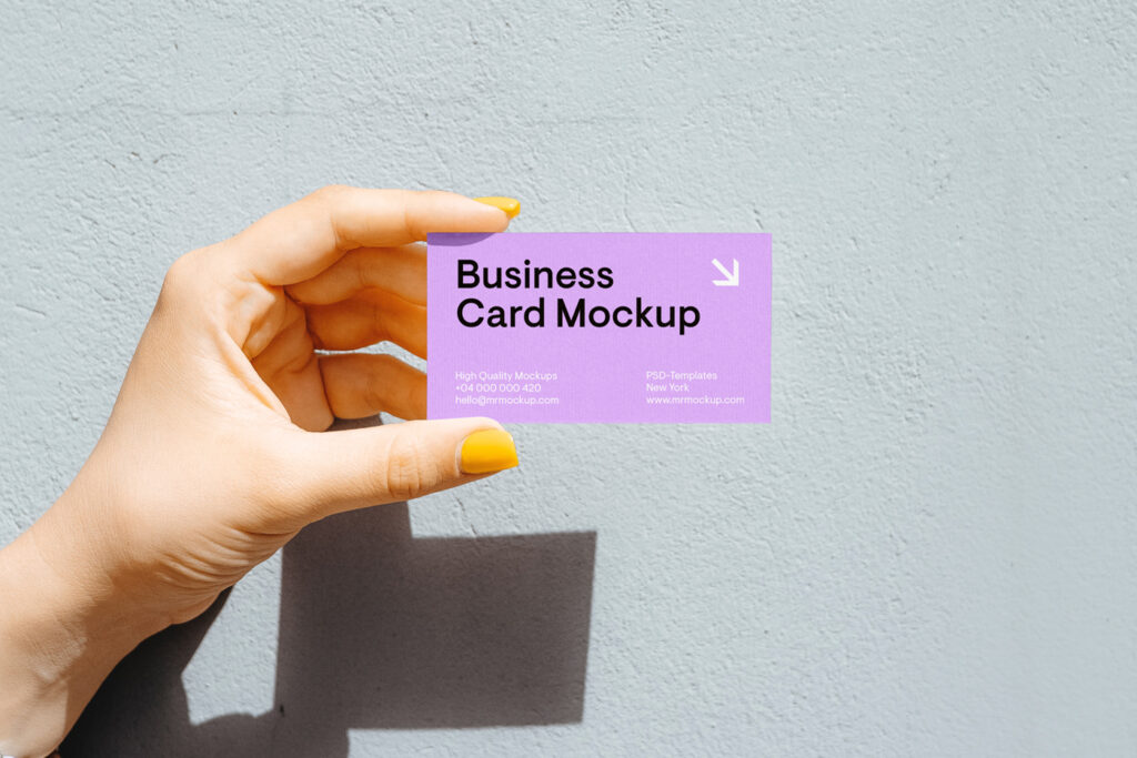 Women holding business card mockup in her hand.