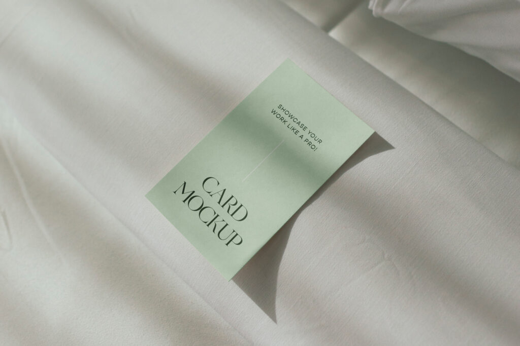 The hotel room card mockup laying on the bed.