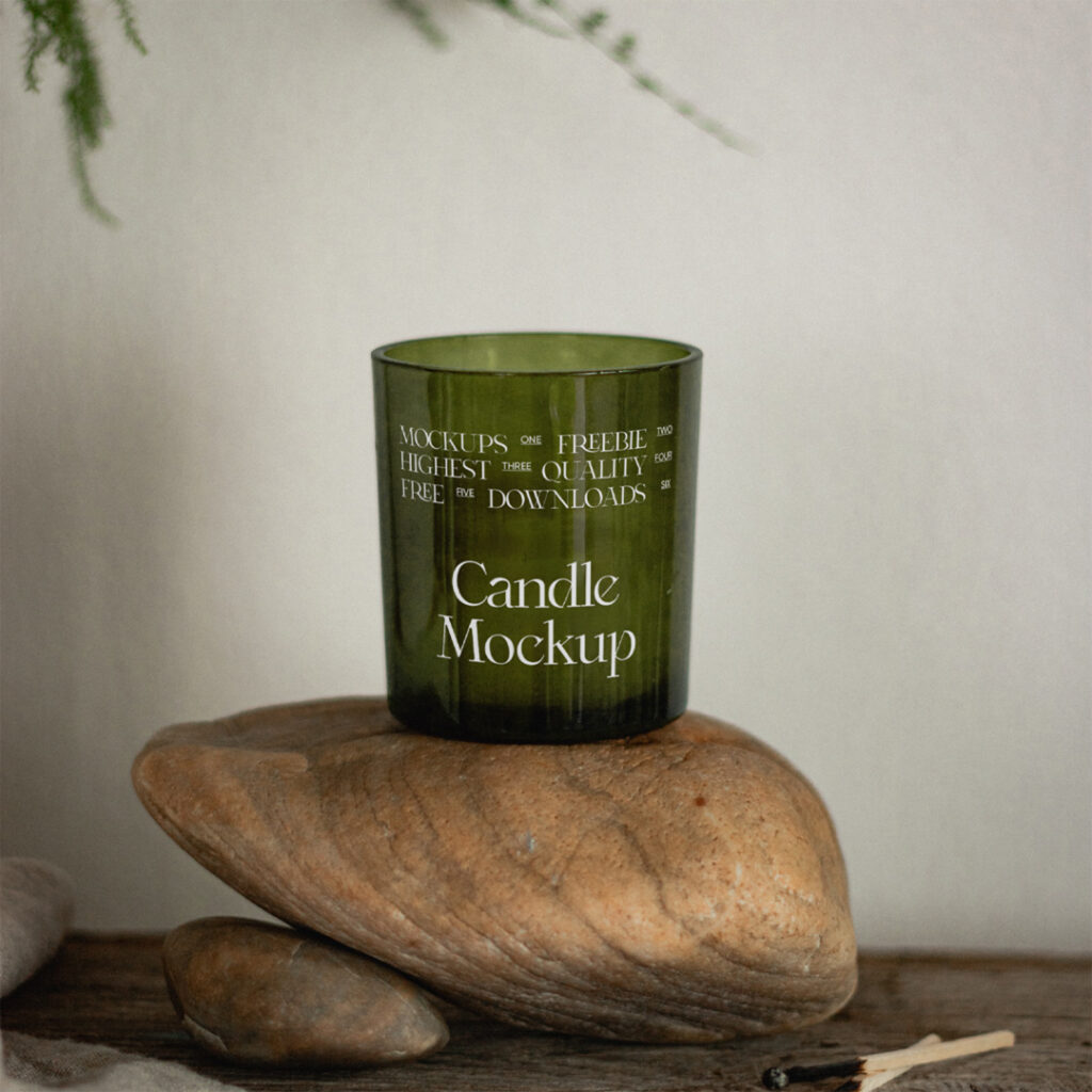 Glass green candle mockup standing on the stone.