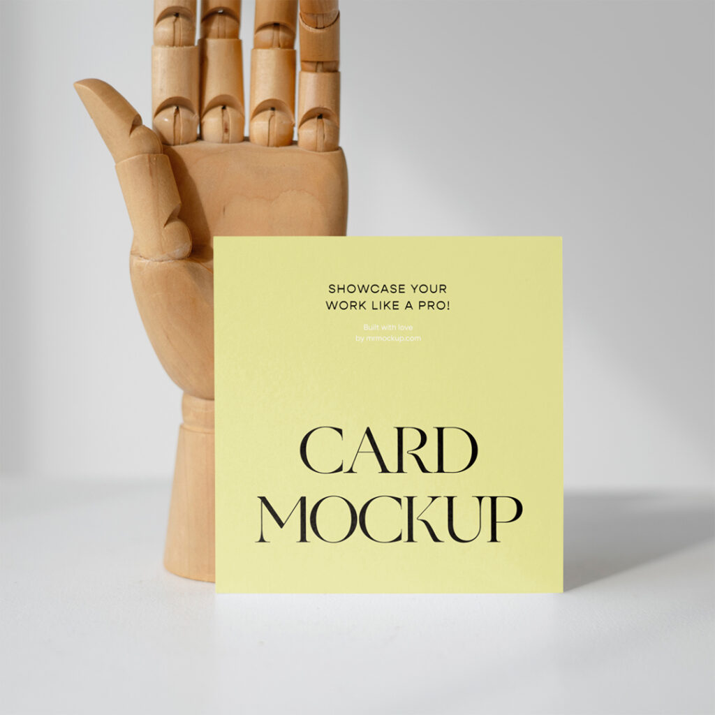 Card mockup with a standing wooden hand at the back.