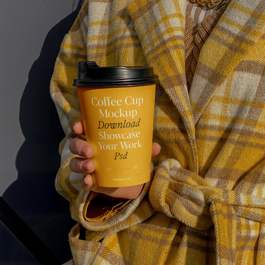 Coffee cup mockup held by woman wearing a bathrobe.