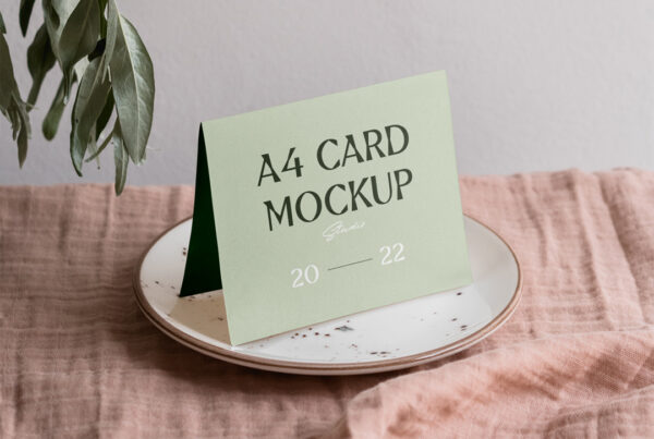 An invitation card mockup laying on the white plate.