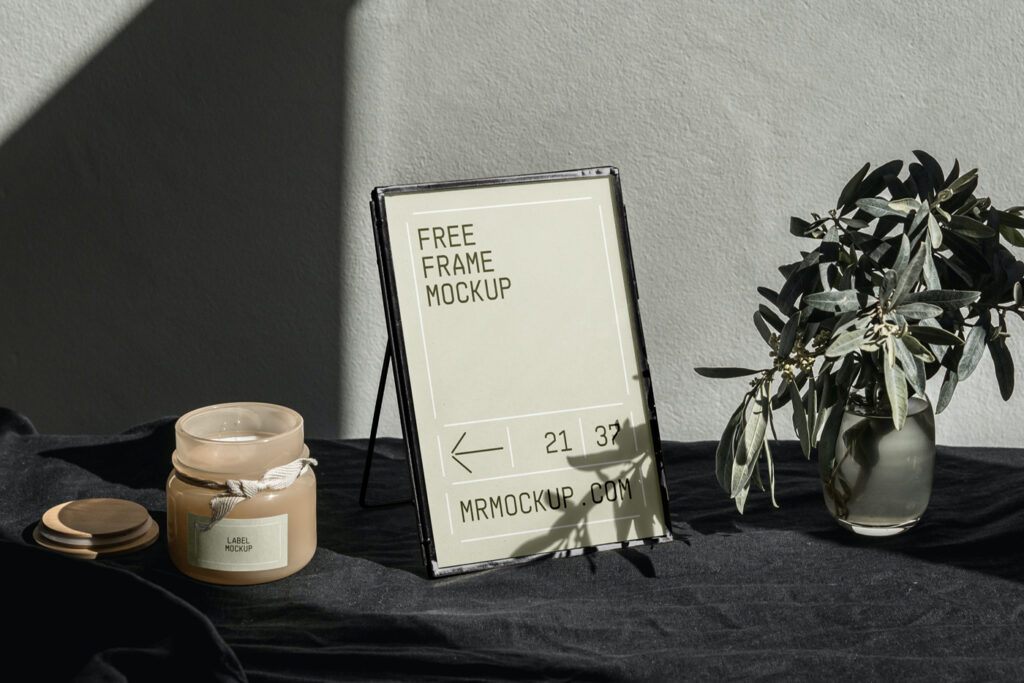 Mini gold frame mockup with flowers on the table.