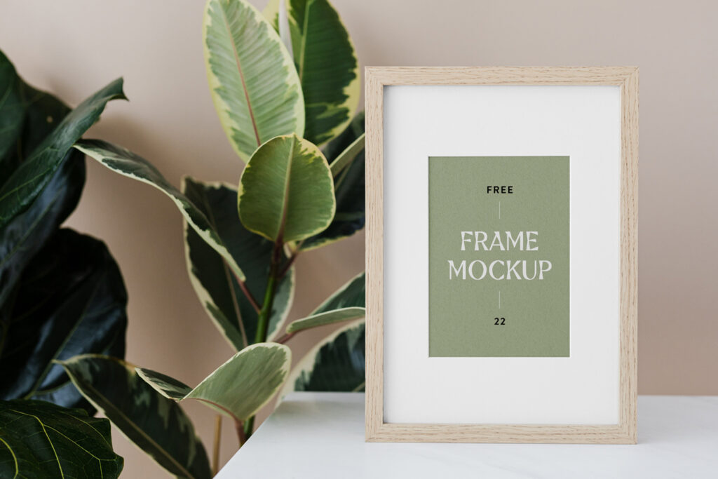 Wood frame mockup standing on the table with plant.