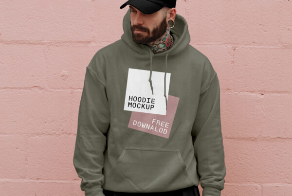 Man in hoodie mockup and cup mockup standing in front of the brick wall.
