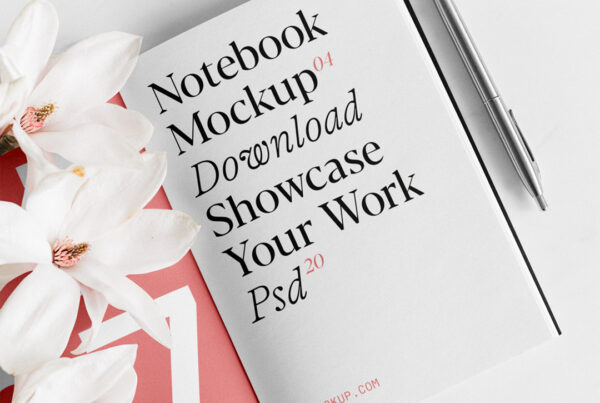 An open notebook mockup with flowers laying on the floor.