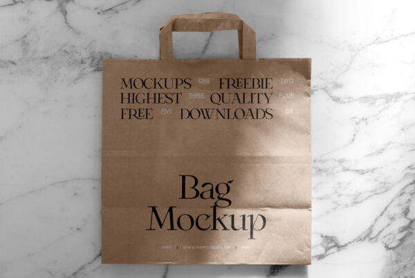 A paper shopping bag mockup laying on the marble floor seen from above.