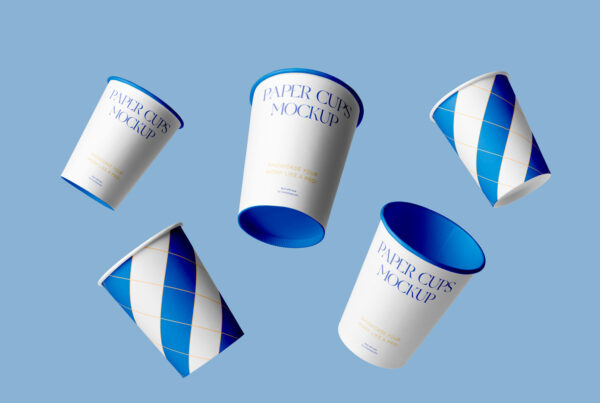 Levitating paper coffee cups mockup composition on the blue background.