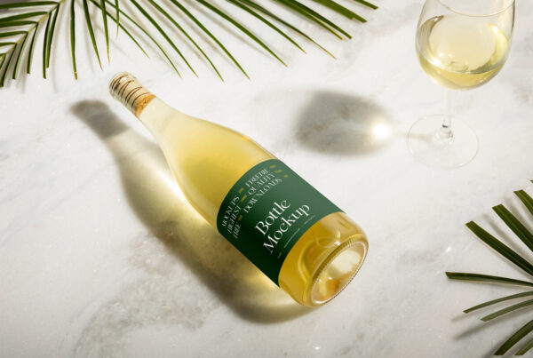 The champagne glass bottle mockup lies on the marble floor.