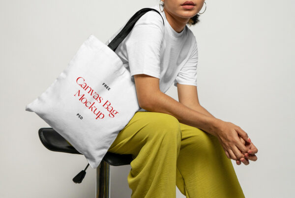 Woman sitting and wearing canvas bag mockup.