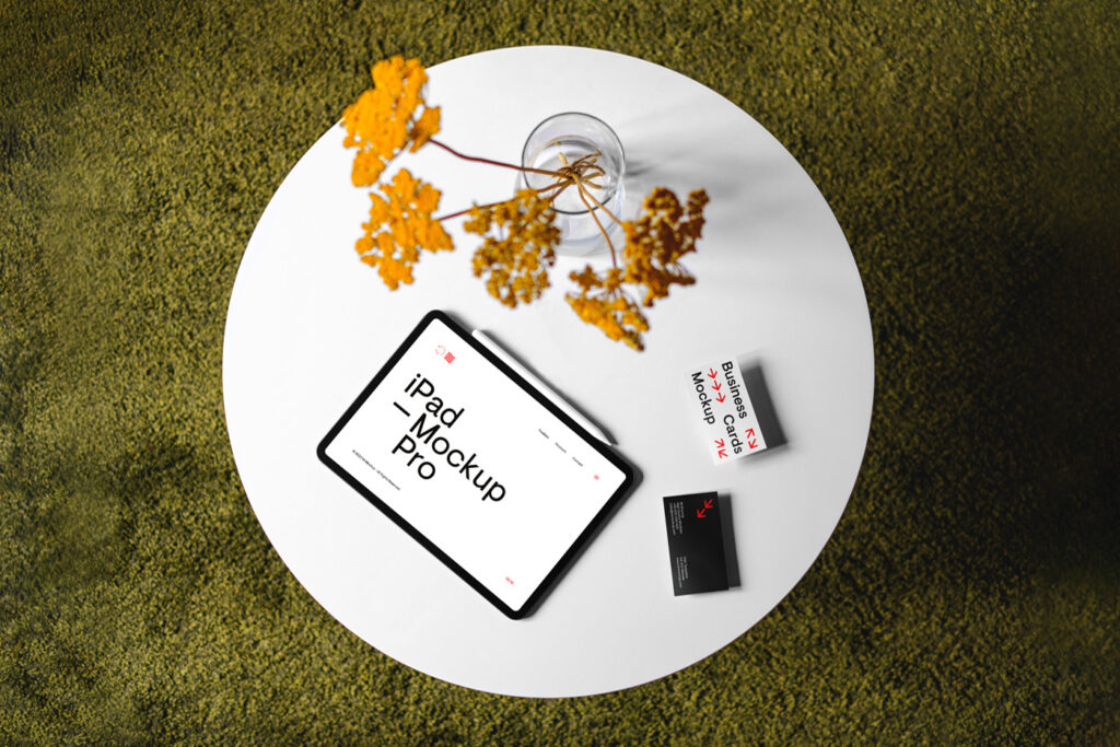 iPad with business cards mockup lies on white circle table.