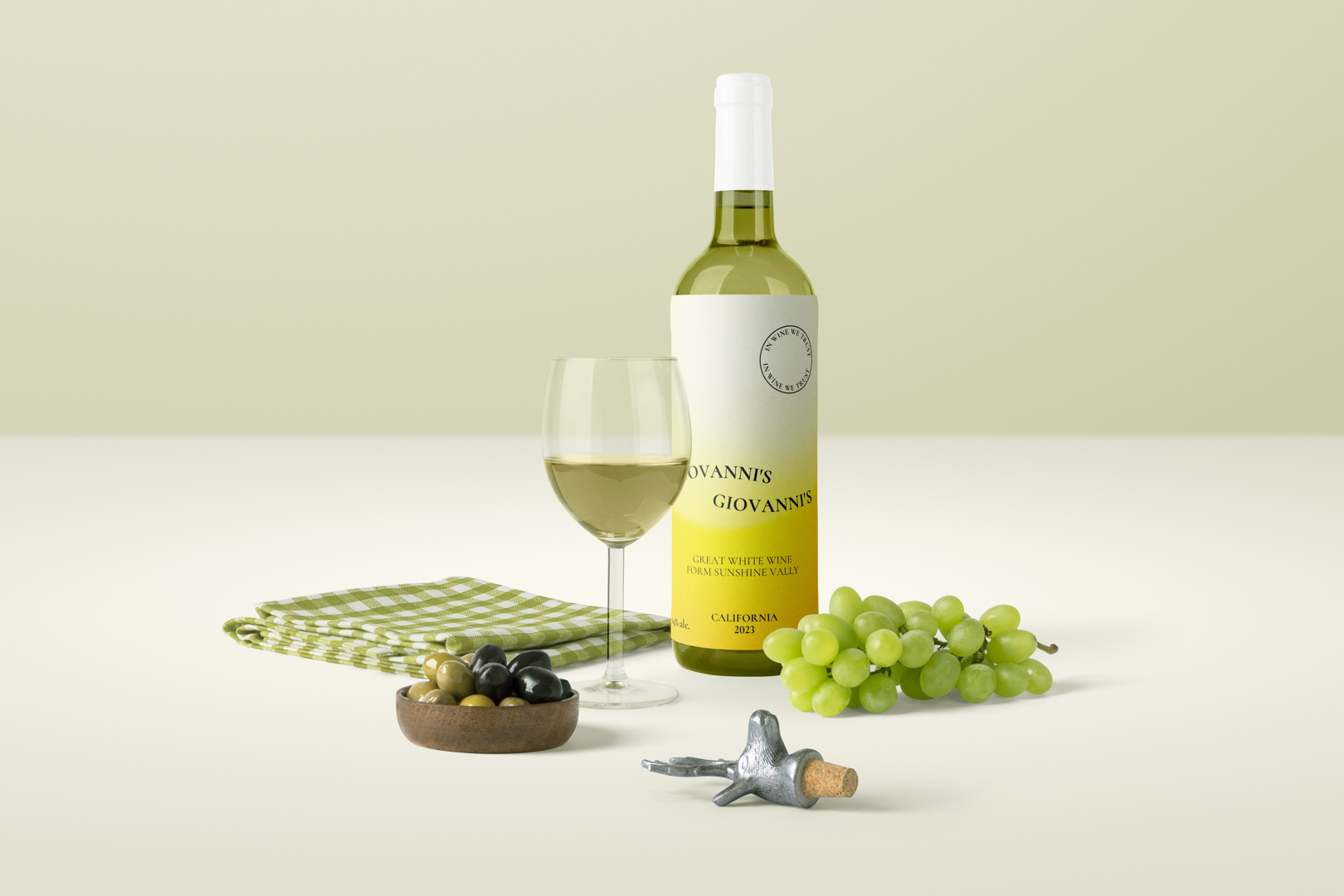 Wine project scene with wine bottle, wine glass, cloth, olives, grapes and corck, made with Front View Mockups.