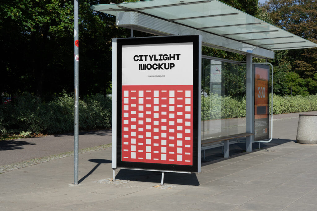 City light poster mockup with a red design on a bus stop.