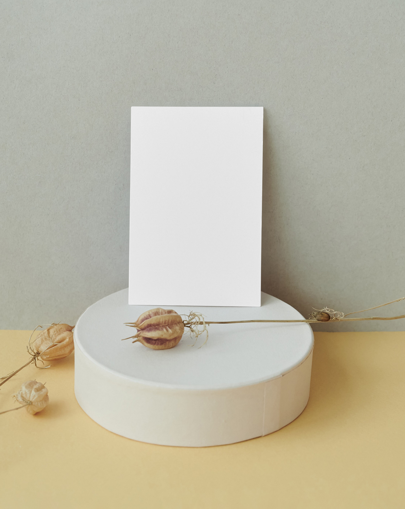 The card mockup is placed on the desk with decorations, seen from the front.