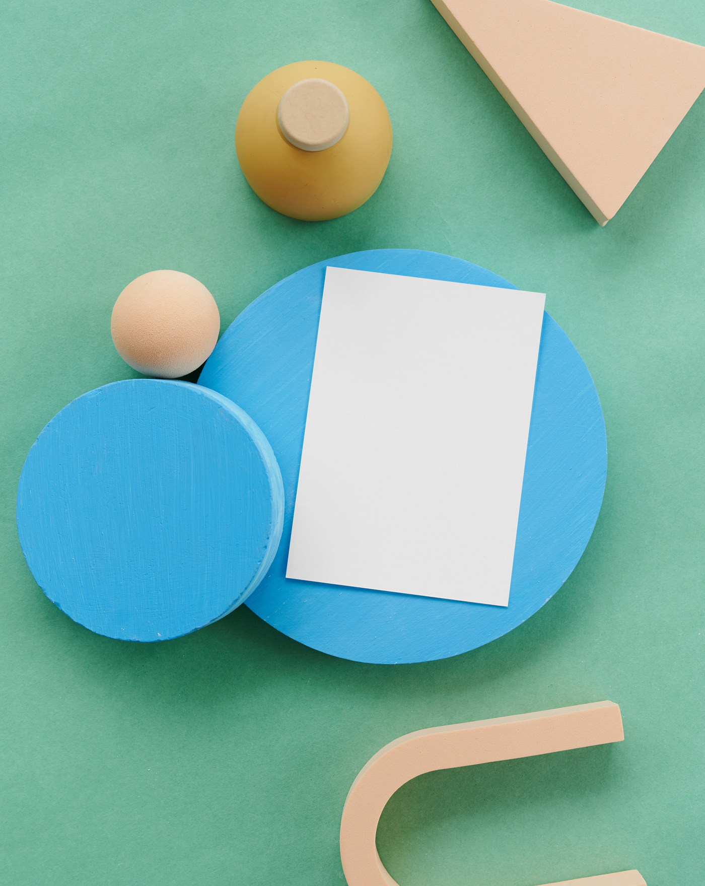 The card mockup is placed on a blue circle block, seen from above.
