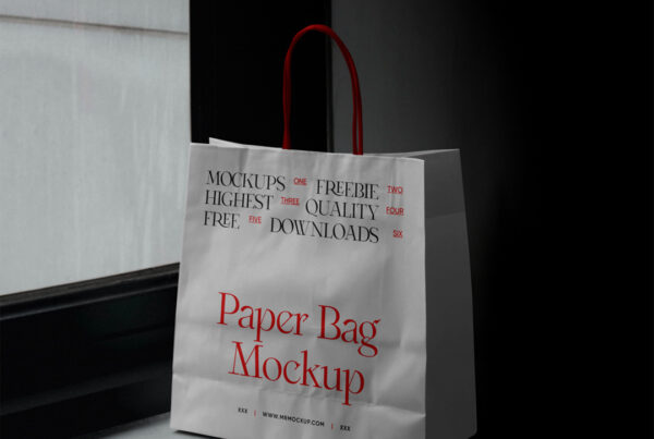 A white paper shopping bag mockup with a red hand standing on a windowsill.