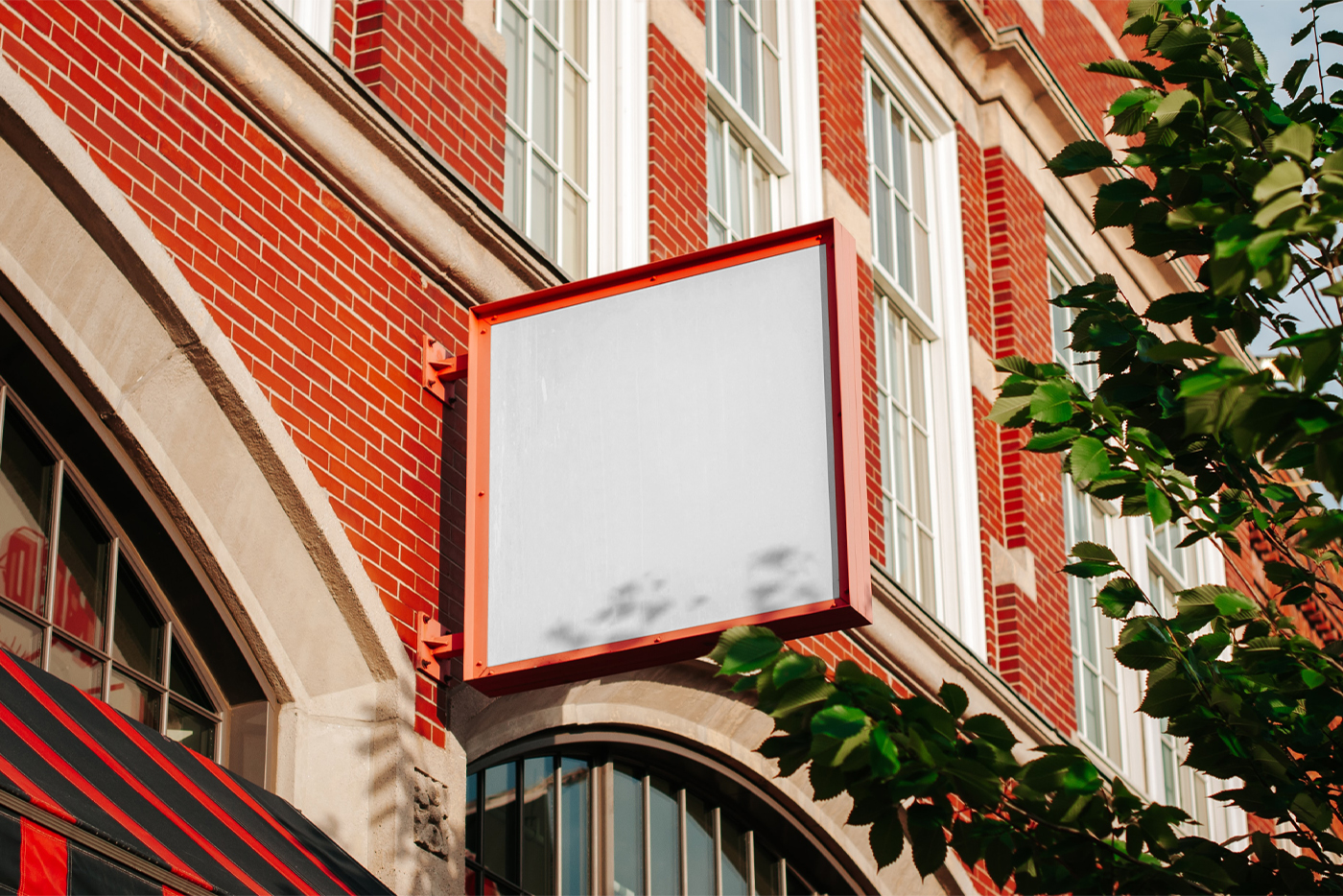 Big metal blank square sign mockup on the facade of a brick building.