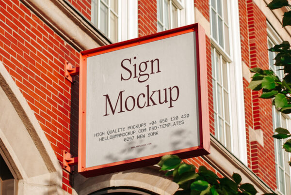 Big metal square sign mockup on the facade of a brick building.