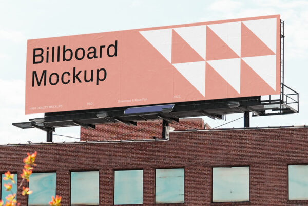 Wide billboard Mockup located on the top of a brick building.