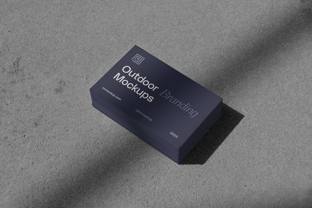 Outdoor branding mockups scene with business cards on the gray floor.