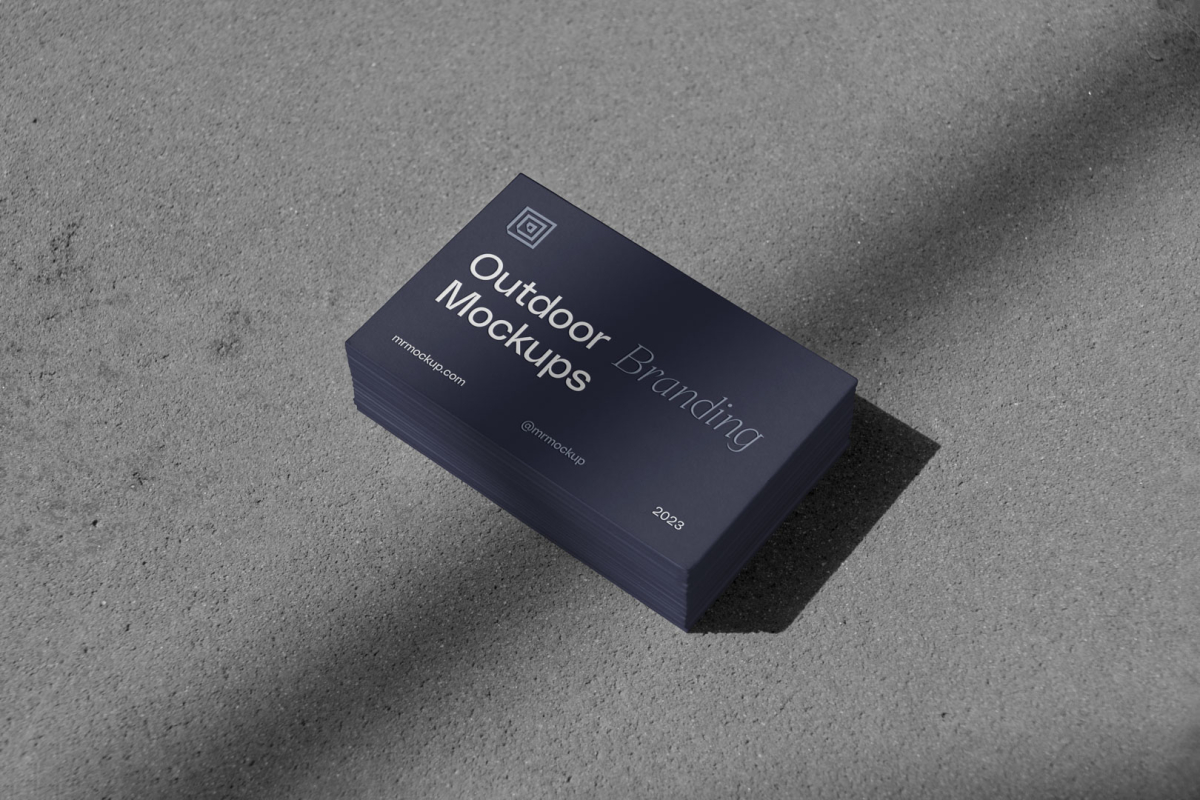 Outdoor branding mockups scene with business cards on the gray floor.