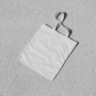 White canvas bag on the white floor from outdoor branding mockups.